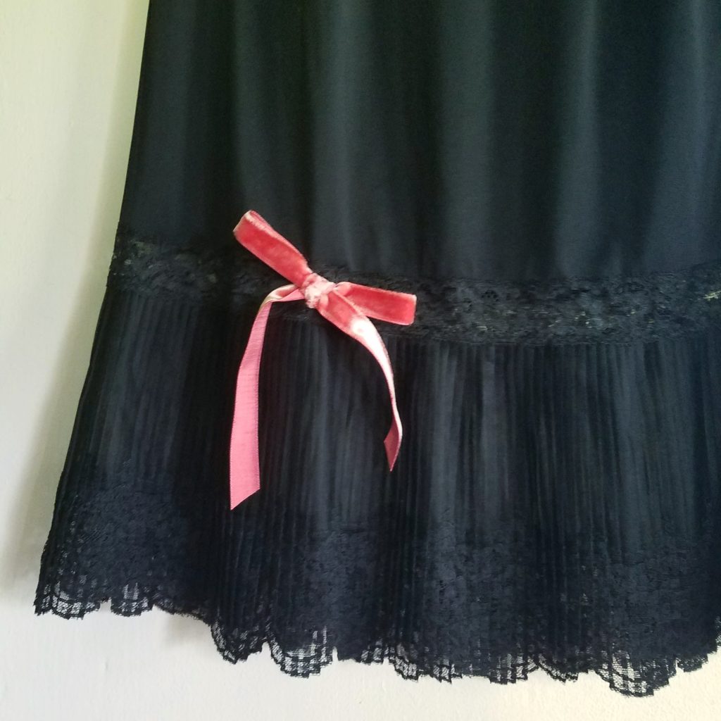 black vintage slip with a pink velvet bow